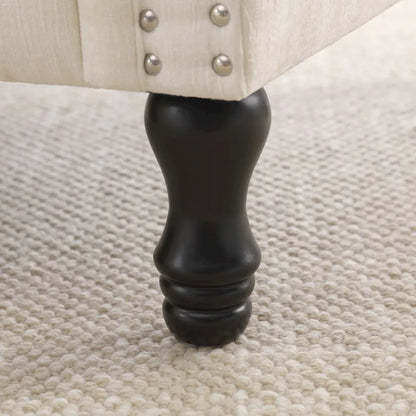 Fauteuil moderne rembourré avec clous décoratifs et pieds en bois